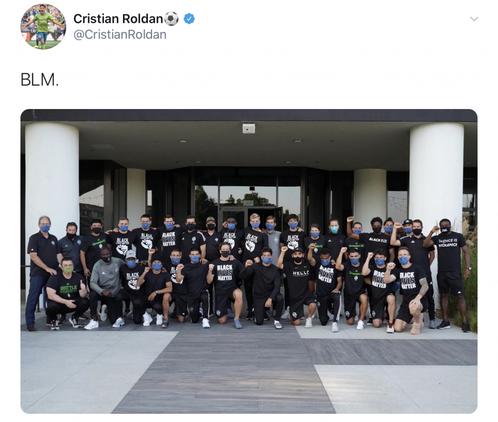 Tweet by Cristian Roldan that reads "BLM" above a picture of the Seattle Sounders FC team, many of whom are wearing Black Lives Matter t-shirts.