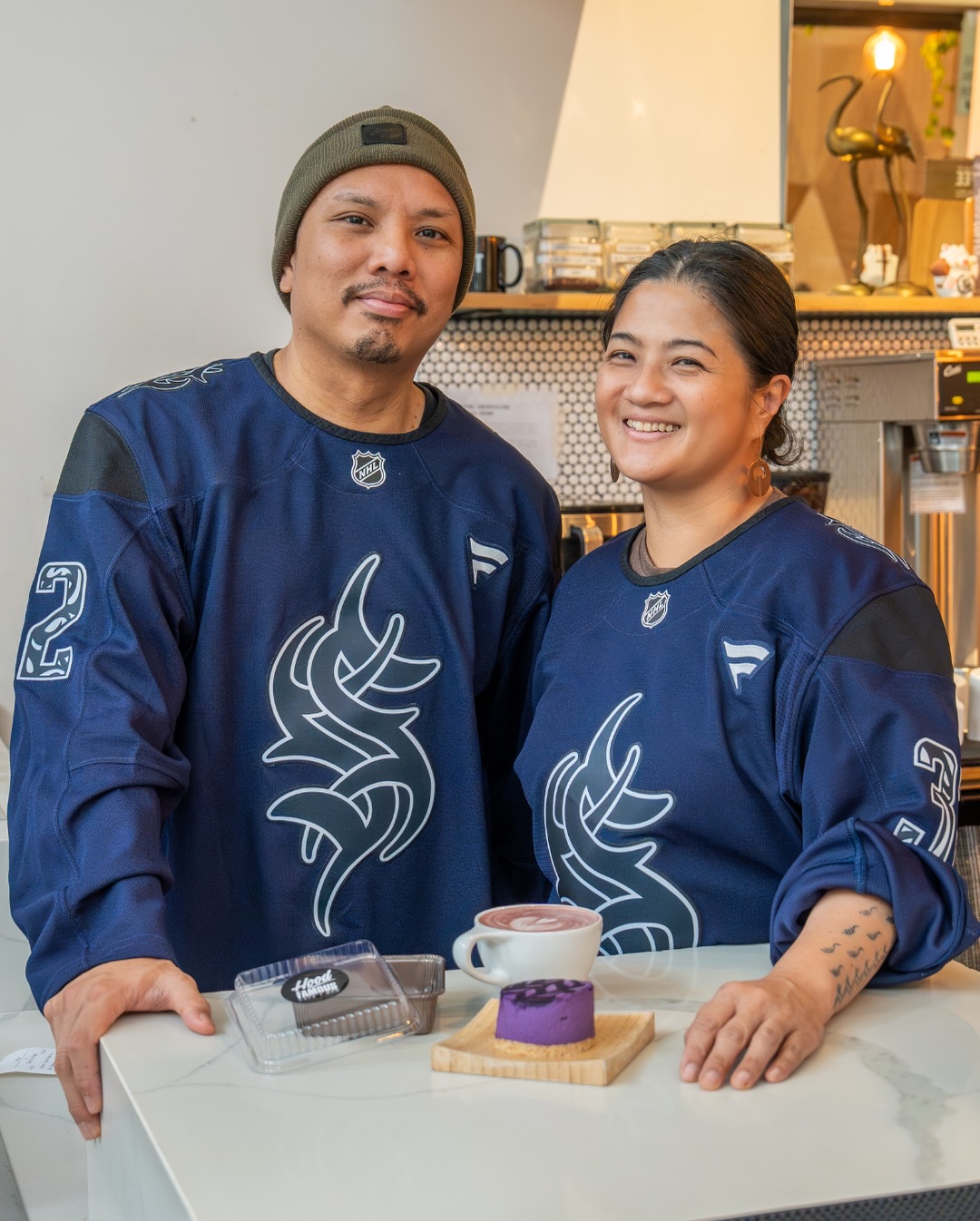 Seattle Kraken’s AANHPI Night is almost here 🏒
Ahead of the game on January 29th, @seattlekraken and @intentionalist_ collaborated to recognize Chera Amlag and Geo Quibuyen of @hoodfamousbakeshop ☕💜
Chera and Geo opened Hood Famous in 2013, bringing Filipino‑American flavor to Seattle. You can enjoy cult-favorites like their ube cheesecake, pandan latte, and more at their Chinatown-ID cafe.
A portion of these special ticket sales will go to Chinatown-International District Business Improvement Area (CIDBIA) - a beneficiary of Anchor Auction.
🎟️: Get your discounted rickets for Thursday’s (1/29) game at the link in @intentionalist_’s bio!
🎨: Artist Kenji Stoll (@kenjihamaistoll) draws inspiration from the punk-era origins of modern tribal tattooing, honoring an often unrecognized legacy of Asian American art that bridges cultures, generations, and creative traditions.
📸: @vlackmedia
#SpendLikeItMatters #AANHPIOwned #SmallBusinessEveryday
