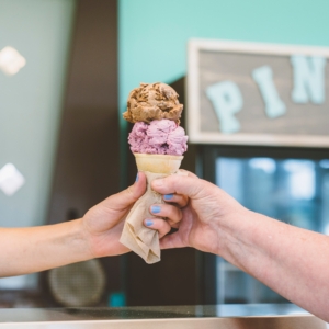Two people holding an ice cream cone at Bliss Small Batch Creamery
