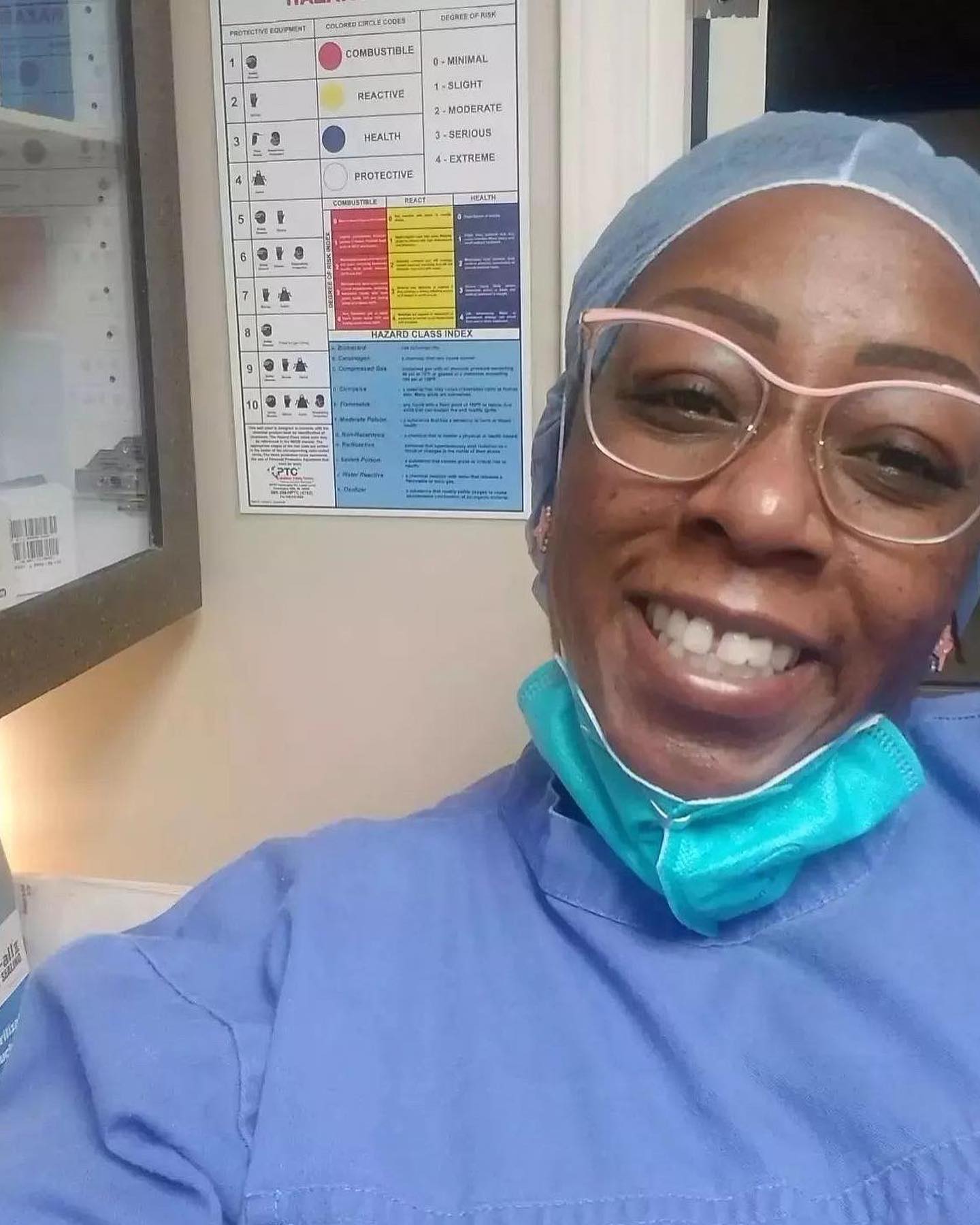 Danni's Tooth Spa owner Danni smiling for the camera wearing her dental scrubs and a face mask pulled down to show her smile