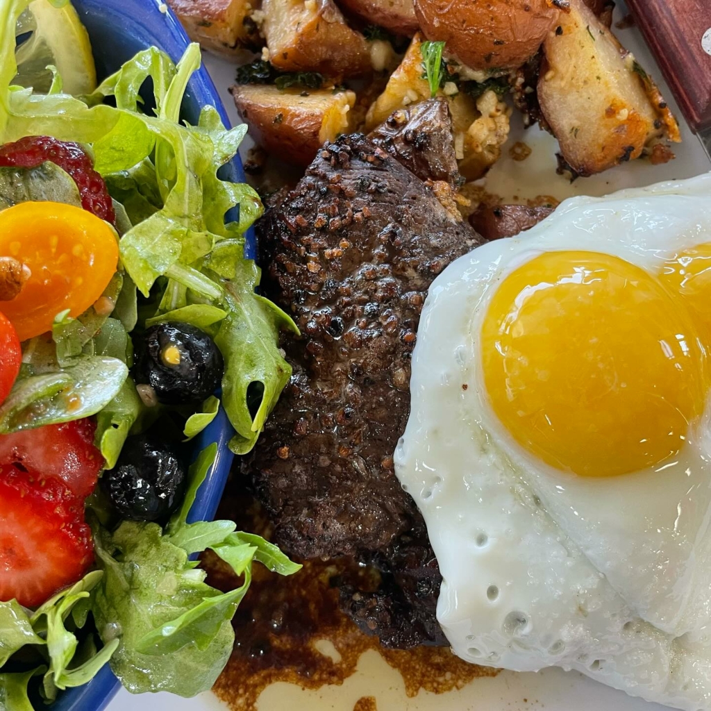 steak and eggs plate with a green salad from Lizzie Lou's Too Cafe