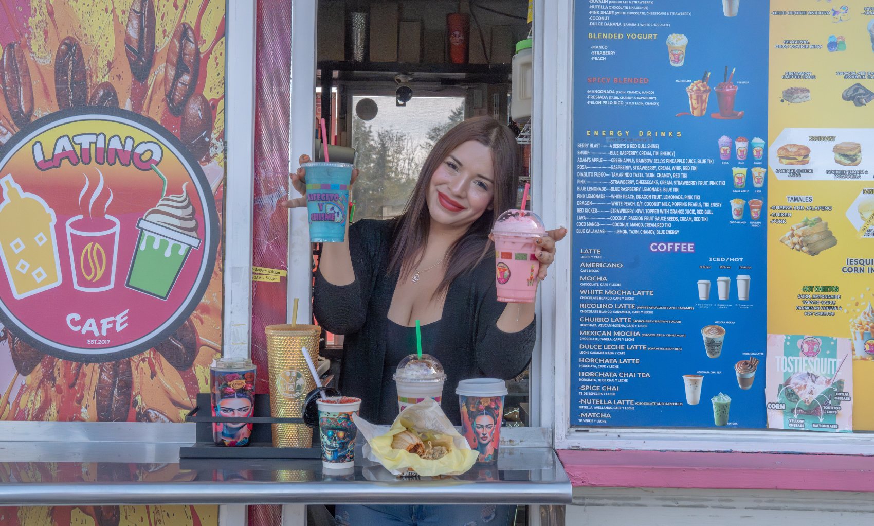 Latino Cafe owner holding two handcrafted drinks